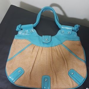 Large and roomy teal and tan rattan shoulder bag.